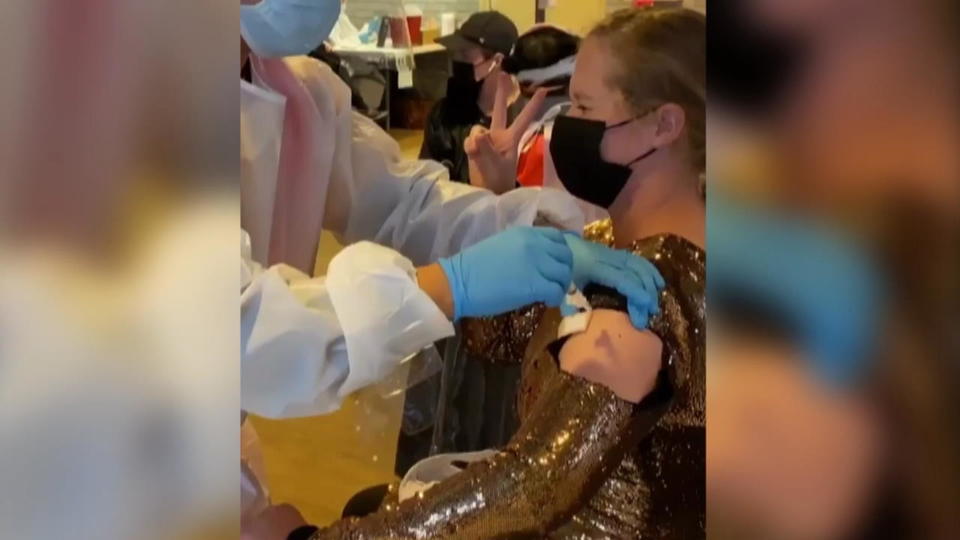 Im Glitzerfummel bringt Amy alle zum Lachen Amy Schumer macht Corona-Impfung zur Party