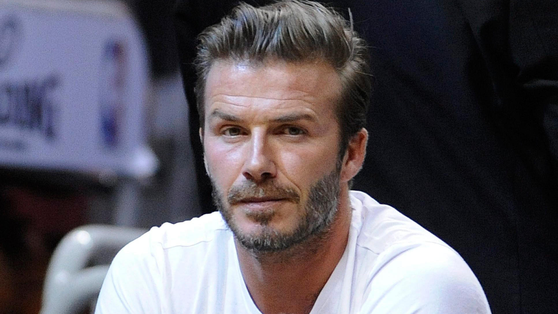 FILE - epa04194381 Former English soccer player David Beckham watches the Brooklyn Nets and the Miami Heat during their Eastern Conference Semifinals NBA playoff game at the American Airlines Arena in Miami, Florida, USA, 06 May 2014. EPA/RHONA WISE 