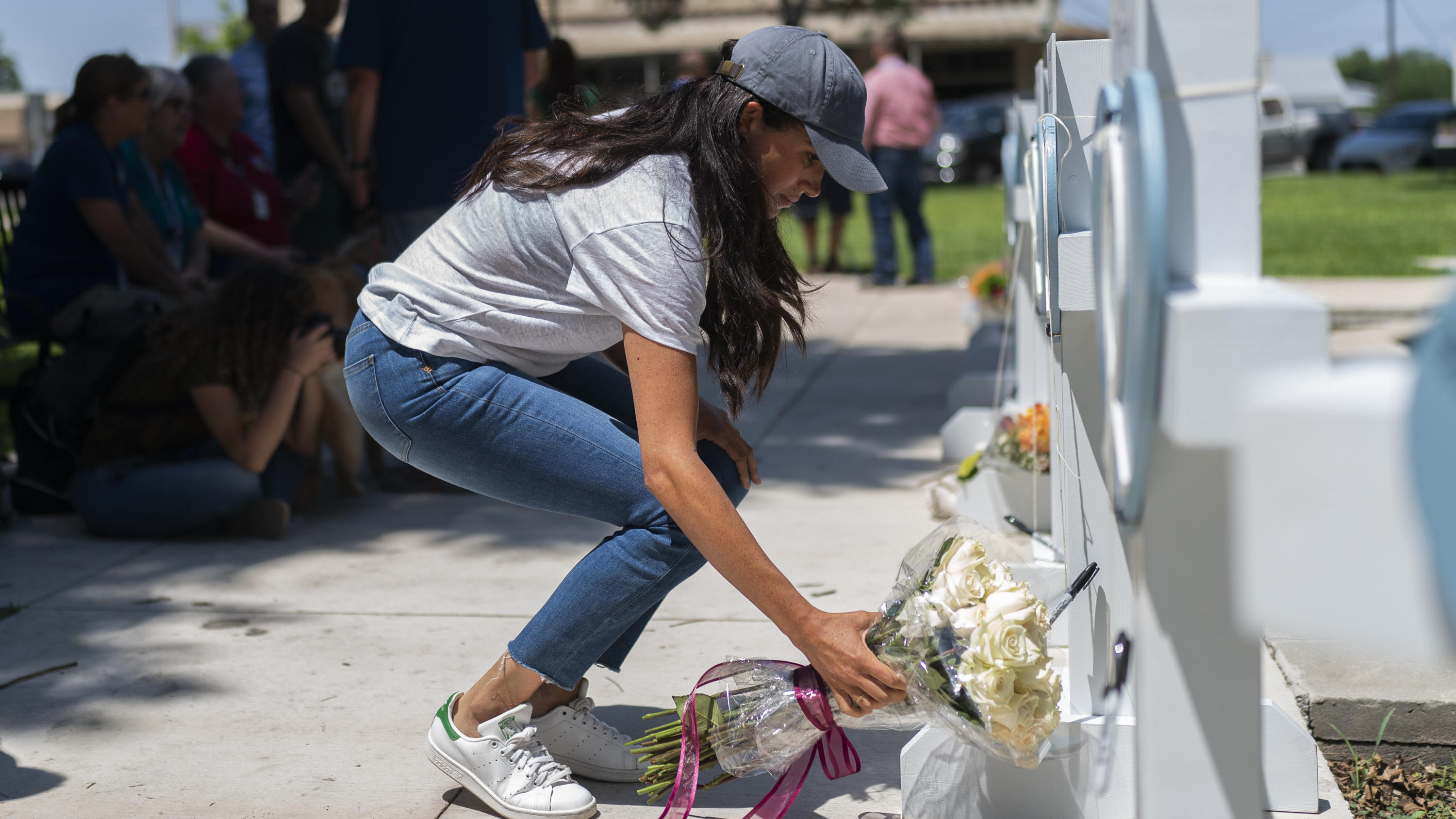 Meghan Markle, Duchess of Sussex, leaves flowers at a memorial site, Thursday, May 26, 2022, for the victims killed in this week's elementary school shooting in Uvalde, Texas. (AP Photo/Jae C. Hong)