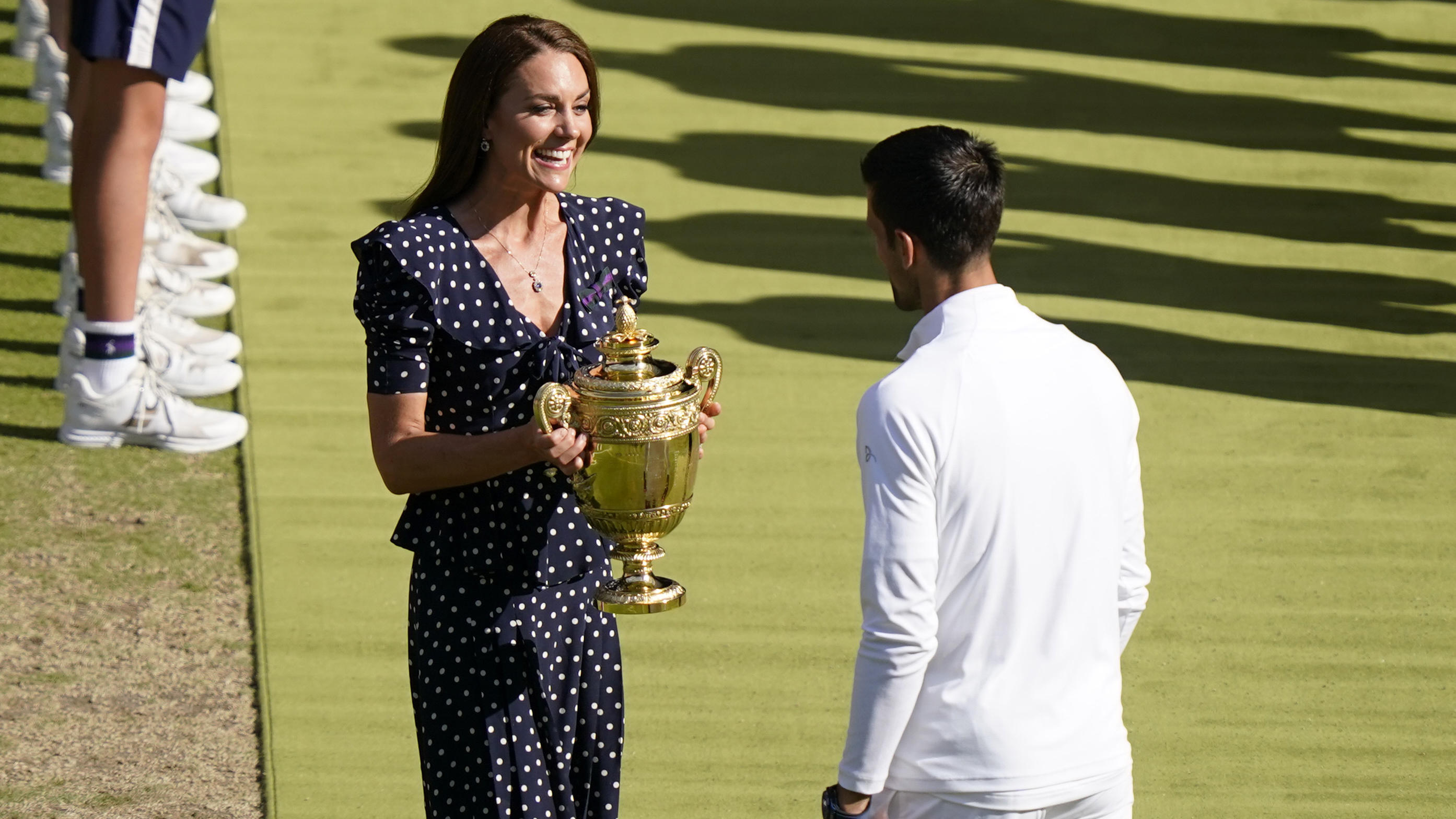 Britain's Kate, Duchess of Cambridge presents the trophy to Serbia's Novak Djokovic after he beat Australia's Nick Kyrgios in the final of the men's singles on day fourteen of the Wimbledon tennis championships in London, Sunday, July 10, 2022. (AP P