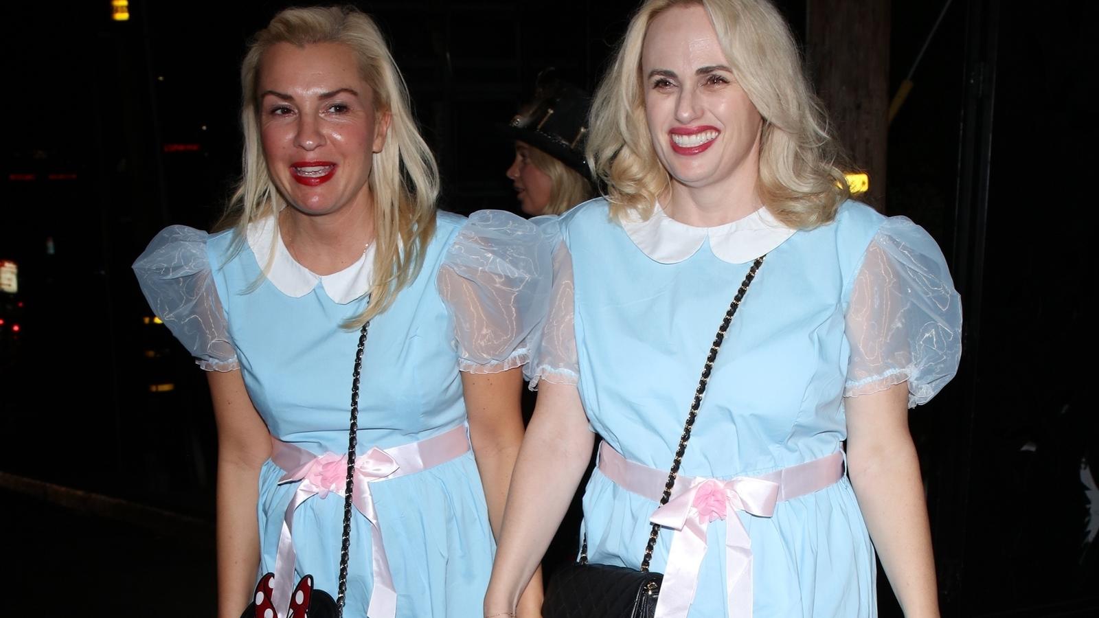 West Hollywood, CA - Rebel Wilson and girlfriend Ramona Agruma look smitten as they hold hands on their way to Halloween party in LA while dressed up as the creepy twins from The Shining.Pictured: Ramona Agruma, Rebel WilsonBACKGRID USA 30 OCTOBER 20